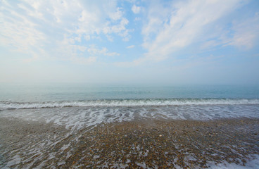 Beautiful morning haze on Mediterranean Sea shore, soft dawn lighting