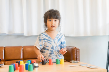 Little asian girl learning materials in a montessori methodology school being manipulated by children.Geometric material in Montessori classroom for the learning of children in mathematics area.