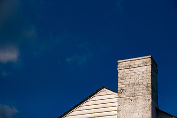 Blue sky with top of roof and chimney