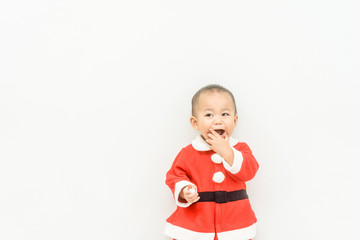 Little baby boy child in Santa suit, laughing and smiling.Baby in red Christmas costume isolated on white background.