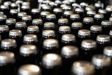 close up of crown caps on beer bottles