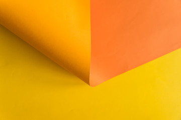 Yellow and orange papers background bending in abstract form. Abstract color paper background.