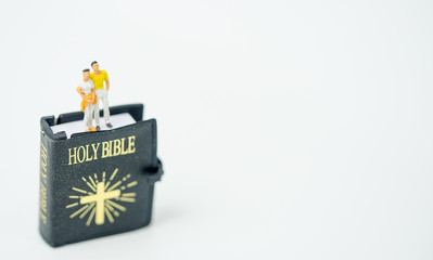 Christianity couple concept.Miniature people couple in love standing on holy bible concept for christianity,counseling before marriage.