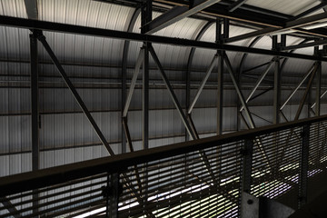 Metal construction of dark colors with beams and railing