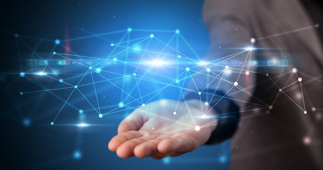 Handsome person holding hologram screen displaying modern cloud based web system technology