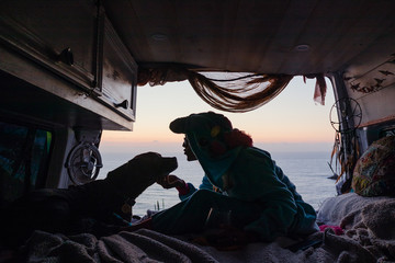 Woman with dog in a camper van