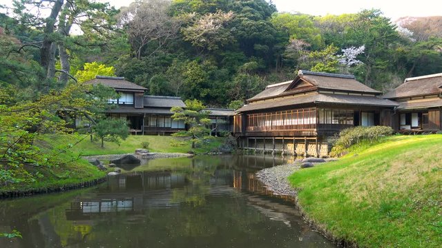 Static Shot of Traditional Tea House by Pond at Japanese Garden in Japan
