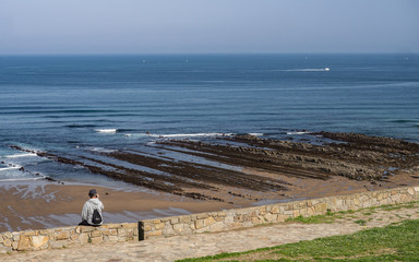 Adult man watching the sea in the coast of Sopelana, Basque Country