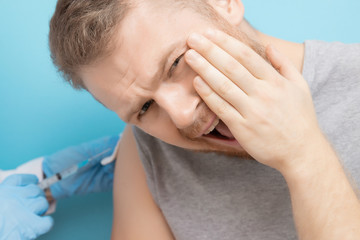 Fear of syringe injections and vaccinations doctor appointment. Man is afraid of nurse