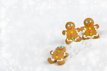Christmas gingerbread men on the background of snow