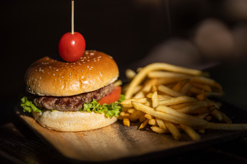 tasty hamburger and fried potatoes
