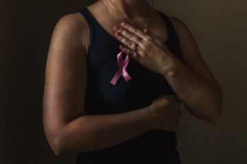 October is breast cancer awareness month,a woman holds a pink ribbon to support people living and sick.Health, international women's day and the concept of the world day of fight against cancer.Noises