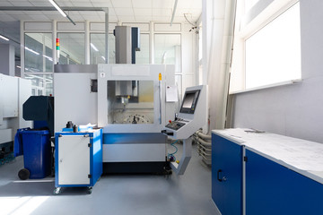 Inside of factory unit with new modern computerized equipment with screen