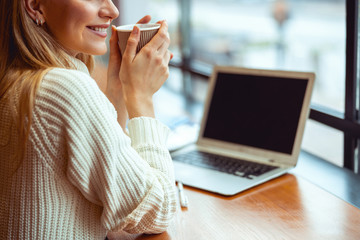 Girl holding a paper cup with both hands