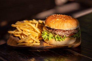 tasty hamburger and fried potatoes