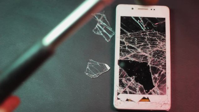 broken phone screen with hammer . device damage repair touchscreen. broken