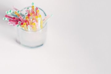 Colorful bright drinking straws on a white background with shadows. Drinking Straw Day.