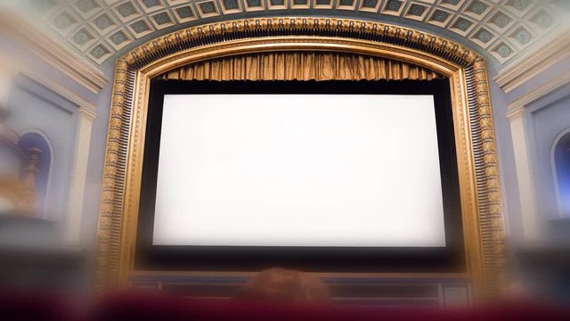 vintage movie theater cinema with white empty screen with large copy space waiting for the premiere of the latest blockbuster movie