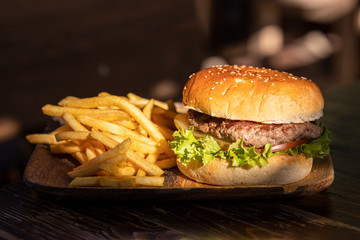tasty hamburger and fried potatoes