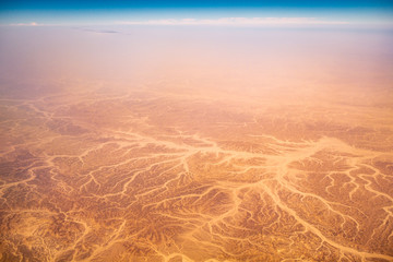 Aerial airplane view of barren Sahara desert landscape in Egypt