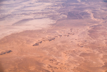 Aerial airplane view of barren Sahara desert landscape in Egypt