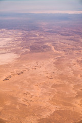 Aerial airplane view of barren Sahara desert landscape in Egypt
