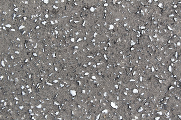 white stone drops on grey asphalt road texture background 