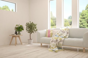 Stylish room in white color with sofa and summer landscape in window. Scandinavian interior design. 3D illustration