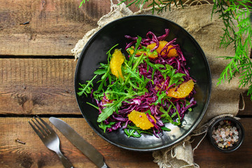 healthy salad orange fillet, red cabbage, arugula (delicious snack, mix leaves lettuce, coleslaw) menu concept. food background. copy space. Top view