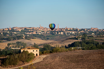 Panorama of Siena at dawn with hot air balloon
