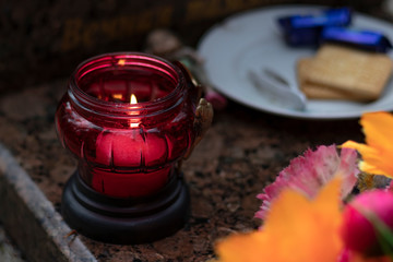 it's raining. the candle is burning. background grave. marble slab.