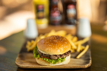 tasty hamburger and fried potatoes