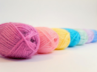 Background from multicolored balls of woolen thread for knitting   