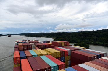 Large container ship transiting Panama Canal, view on the deck loaded with containers. 