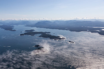 Aerial Landscape View of Beautiful Pacific Ocean Coast with Coastal Mountains at the background during a sunny summer morning. Taken near Tofino and Ucluelet, Vancouver Island, BC, Canada.
