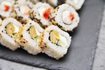Japanese rolls on stone background.