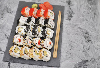 Japanese rolls on stone background.