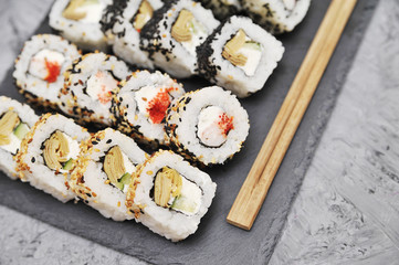 Japanese rolls on stone background.