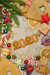 Christmas background with gingerbread. Christmas toys, cookies and candy on paper. The inscription 2020.