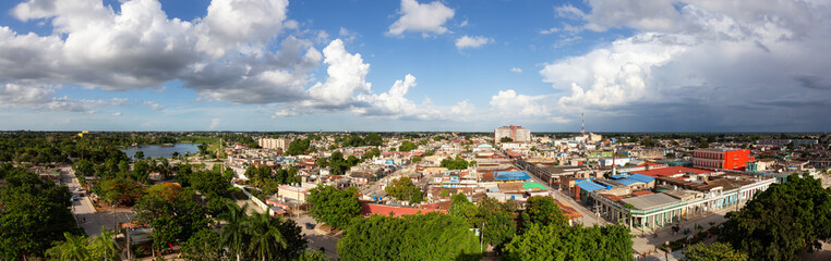 Fototapeta na wymiar Aerial Panoramic view of a small Cuban Town, Ciego de Avila, during a cloudy and sunny evening. Located in Central Cuba.