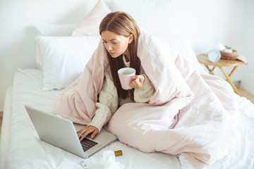 Concentrated girl reading income message on gadget