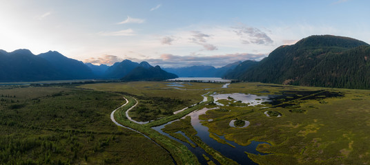 Beautiful Aerial Panoramic View of Canadian Mountain Landscape during a vibrant summer sunset. Taken near Pitt Lake, Near Vancouver, British Columbia, Canada.