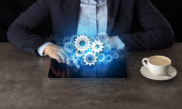 Business woman working on tablet with setting and gear concept