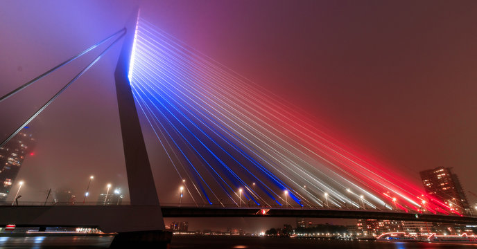 erasmusbrug by night with the dutch flag 