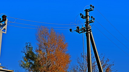 The pillar is electric. Electric wires. Power lines. Crows on wires