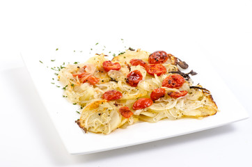 Potato Frittata topped with Onions and Fried Tomatoes on white plate on White BG with Back Light