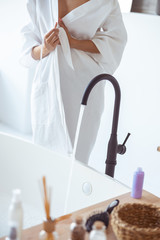 Close up of young woman that standing near bath