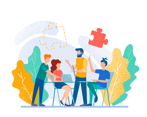 Men and women sitting at desk and standing, working at computers and talking with colleagues