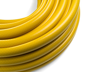 Hose for watering yellow color. Garden hose in a skein. Isolated on a white background.