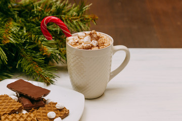 Winter whipped cream hot coffee in a red mug with marshmallow. christmas postcard
